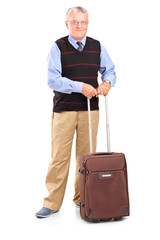 Full length portrait of a senior gentleman standing with a trave