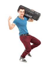 Full length portrait of a young muscular man posing with a radio