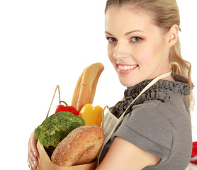 Woman in apron holding grocery bag