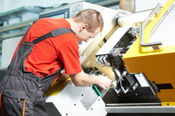 worker operating CNC machine center