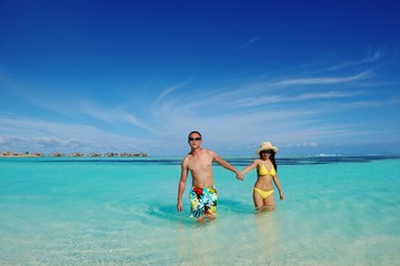 happy young  couple enjoying summer on beach