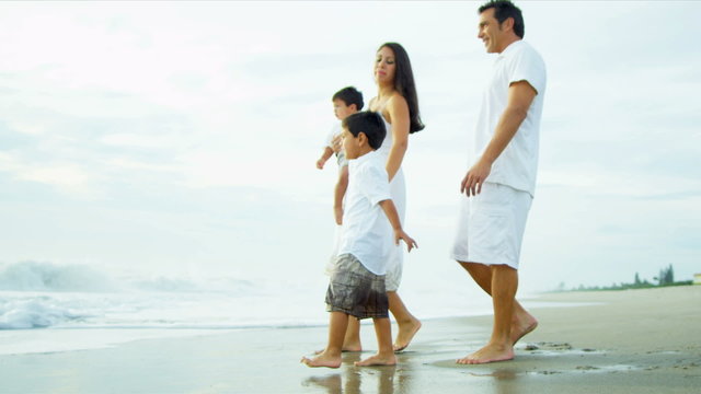 Hispanic Loving Family Spending Vacation On Beach