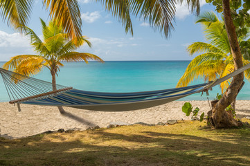 Fabric hammock by turquoise sea