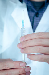 doctor with medical syringe in hand