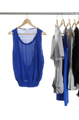 blue shirt and Fashion female clothing hanging on hangers