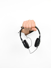 male hand holding black headphones