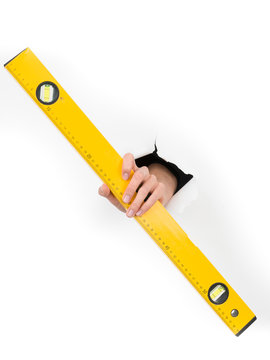 Hand Holding A Spirit Level Through White Paper