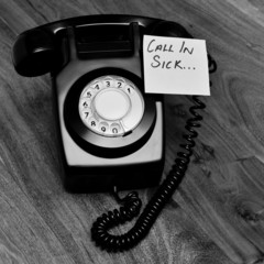 Black retro telephone with reminder note to call in sick