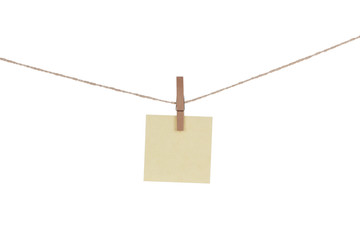 Blank paper cards hanging on clothespins 