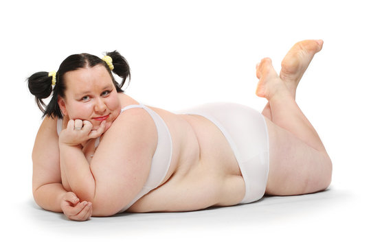 Overweight woman dressed in bikini on a white background.