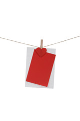 Blank paper cards hanging on clothespins 
