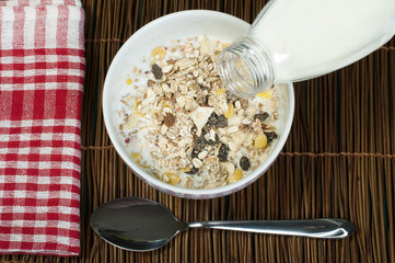 Muesli breakfast in package.Bottle milk and spoon