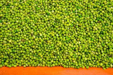 green pea on orange table background