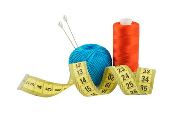 Yellow measuring tape and threads isolated on white