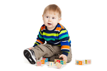 baby playing with wooden toy cubes with letters. Wooden alphabet