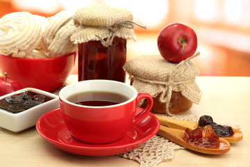 light breakfast with tea and homemade jam, on wooden table