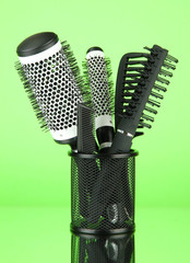 Iron basket with combs and round hair brushes,