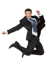 Young happy caucasian businessman jumping in the air