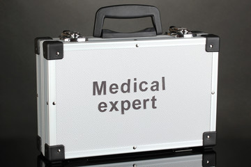 Silvery diplomat (suitcase) on grey background