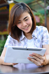 Fototapeta premium Beautiful young student have good news on the tablet screen