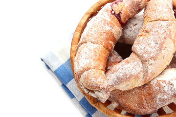 Taste croissants in basket isolated on white.
