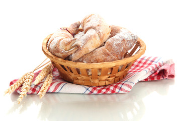 Taste croissants in basket isolated on white.