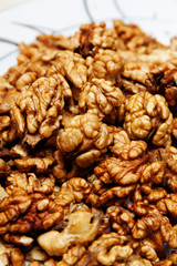 Raw wallnuts in a plate, vertical shot