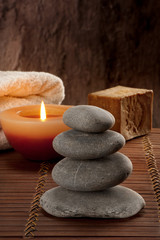 Fototapeta na wymiar SPA atmosphere with four stones with candle light and soap