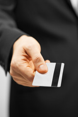 man in suit holding credit card