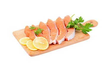 Salmon steak with parsley and lemon, isolated on white