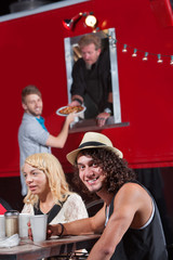 Smiling Man with Friends at Food Truck