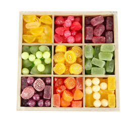 Multicolor candies in wooden box, isolated on white