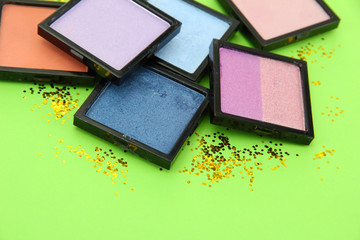 Beautiful bright eye shadows on green background