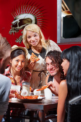 Diverse Group Eating Pizza Outside