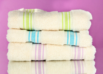 Bath towels on purple background