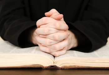 Priest reading from the holy bible, close up