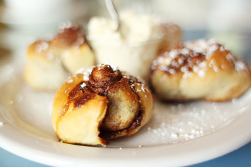 Obraz na płótnie Canvas Fresh baked gourmet cinnamon rolls with whipped frosting.