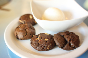 Cookies and ice cream on a dish.