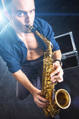 Fototapeta na wymiar Young man playing the Saxophone.