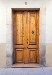 Double wooden door with knocker and mail slot in Sarrià quarter