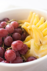 grape and starfruit in a bowl