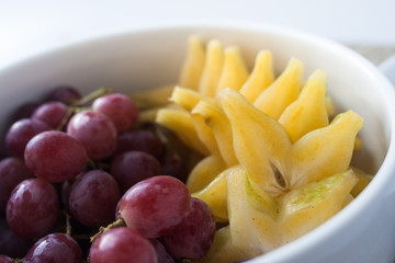 grape and starfruit in a bowl