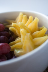 grape and starfruit in a bowl