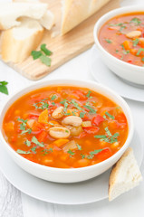 Vegetable soup with white beans in a bowl vertical