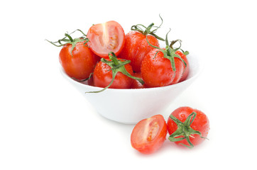 wet cherry tomatoes in a white bowl isolated