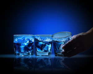 Three glasses of blue liquid