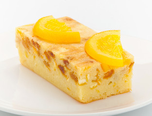Orange cake melted with pieces of orange and topping on