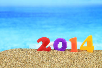 Multicolored new year 2014 on the beach
