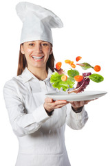 Happy cook woman holding a dish with floating vegetables