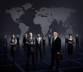 business team formed of young businessmen standing
